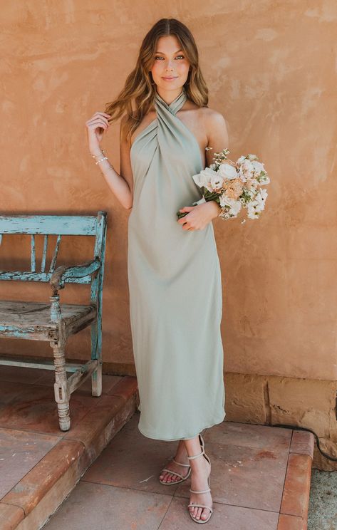 Our best selling halter maxi is now in midi length! This midi is cut on the bias to give that perfect slip draping we're all looking for. The top softly wraps around your neck for a flattering high neck and leaves a dramatic open back. Beyond chic for a bridal party and a new go-to for special occasions and events! Bridesmaid Dress Colors Summer, Moss Bridesmaid Dress, Metallic Bridesmaid Dresses, Garden Wedding Dress Guest, Maternity Dress Wedding Guest, Olive Green Bridesmaid Dresses, Mismatched Dresses, Pastel Bridesmaids, Casual Bridesmaid Dresses