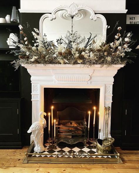 black living room with close-up of white fireplace featuring a dramatic spray of white florals Black Fireplace Wall, Black Living Room Ideas, Black Painted Walls, Painted Bookshelves, Black Accent Walls, Photograph Display, Black Fireplace, Living Room Decor Gray, White Fireplace