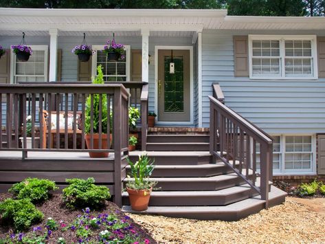 Before a home makeover, this home had a tiny front porch and narrow, steep stairs. The home's transformation included the building of an extended deck across the front of the house. Now the home's entrance feels fresh and inviting. Steep Front Porch Steps, Landscaping For Split Level Home Front Yards, Raised Front Porch, Front Deck Ideas Entrance, Verandah Ideas, Steep Stairs, Small Front Yards, Porch Extension, Front Porch Deck