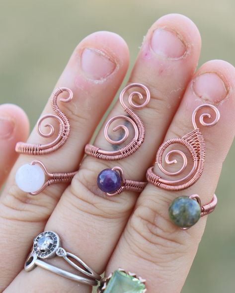 These adjustable swirly rings are perfect for multiple finger sizes, and feature some fine copper wire weaving! There are multiple crystal beads to choose from, and they are all listed on my website for anyone interested!:) • • • • • #wirewraprings #crystalbeadrings #crystalbeadsjewelry #wovencopper #crystalrings #crystaljewelry #wirewrapping #wirewrap #wire #wirejewelry #wireart #wirewrappedjewelry #copperjewelry #copperwirejewelry #copperwirewrap #wirerings #crystalring #diywirejewelry #cr... Wire Wrapped Crystal, Wire Jewellery, Copper Wire Jewelry, Wrapped Crystal, Wire Ring, Wire Wrapping Crystals, Diy Wire Jewelry, Handmade Wire Jewelry, Wire Rings