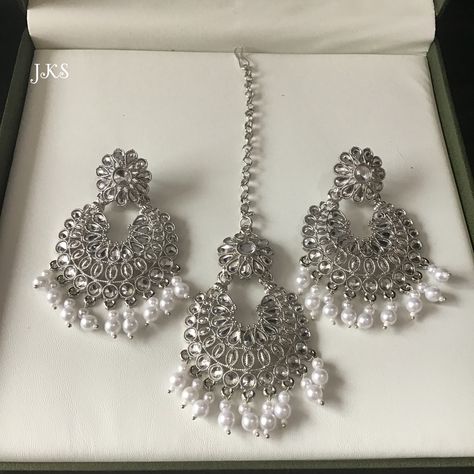 Beautiful new gorgeous element and high quality silver plated Kundan,Pearl handcrafted wedding chandbali earrings and tikka set. Use the finest Kundan stones for that dazzling and dramatic look. Main Colour: Silver Earrings Back: Push Back Stone Colour: Clear White Pearl Colour: White Earrings Size: L x 8cm / W x 5cm Tikka Size: W x 5 cm / L x 8 cm + 10 cm chain Silver Jewelry Indian Wedding, White Earrings Indian, Indian Jewellery Earrings, Tikka Jewelry, Pakistani Jewellery, Pakistani Earrings, Aesthetic Jewellery, Neck Pieces Jewelry, Crystal Bead Jewelry