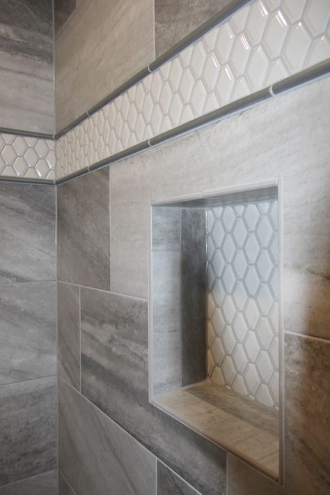 Gray Tiled Shower with White Hexagon Tiled Accent Strip and Niche Tile Shower Accent Strip, Niche Bathroom, Shower Update, Shower Accent Tile, Tiled Showers, Patterned Bathroom, Gray Shower Tile, White Hexagon Tiles, Patterned Bathroom Tiles