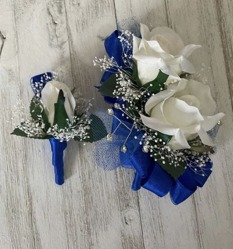 I like this with just the white flowers and blue ribbon Blue And Silver Boutonniere, Royal Blue And White Boutonniere, Blue And White Corsage And Boutonniere, Wrist Corsage For Royal Blue Dress, Royal Blue Prom Flowers Wrist Corsage, Prom Wrist Corsage Ideas Royal Blue, Corsage And Boutonniere Set Blue, Dark Blue Corsage And Boutonniere, Royal Blue Corsage And Boutonniere Prom