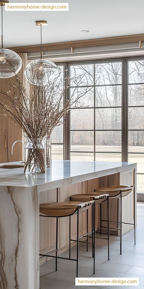 An industrial lighting setup in the kitchen room brings a modern touch to the farmhouse design. Farmhouse Kitchen Waterfall Island, Mountain Modern Dining Room, Waterfall Island, Large Kitchen Island, Sleek Kitchen, Mountain Modern, Lighting Setups, The Farmhouse, Large Kitchen