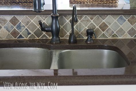 Oil-rubbed bronze faucet and slate backsplash Stainless Steel Sink With Bronze Faucet, Black Tile Backsplash, Oil Rubbed Bronze Kitchen Faucet, Slate Backsplash, Cream Kitchen Cabinets, Bronze Kitchen Faucet, Oil Rubbed Bronze Faucet, White Kitchen Backsplash, Stainless Sink