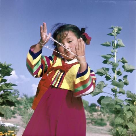 size: 16x16in Giclee Print: A young Korean girl in traditional dress playing Cat's Cradle : Cinematic Poses, Korean Traditional Art, Tradition Photography, Traditional Korean Art, Traditional Korean Hanbok, Fisheye Photography, Traditional Korean House, Korean Photography, Cat's Cradle