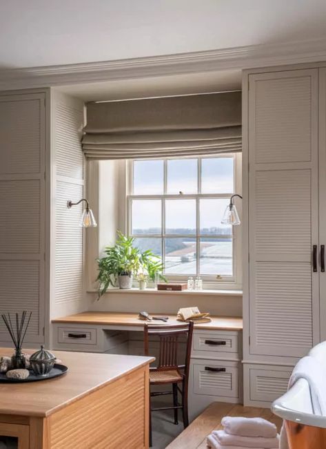 A dressing table underneath a window with field beyond Table Under Window Bedroom, Window Seat And Dressing Table, Dressing Room With Desk, Window Cupboard Bedroom, Wardrobe Window, Build In Wardrobe Around Window, Closet Around Window With Desk, Window Dressing Table, Dressing Table In Window