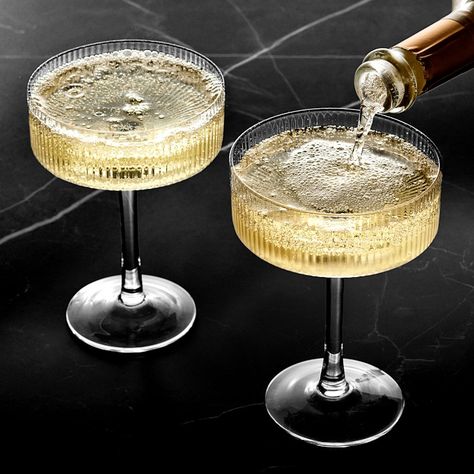 Ribbed vertical bands accentuate the modern, linear silhouette of our mouth-blown glassware. With their wide bowls and straight edges, these expertly crafted coupe glasses are ideal for serving sparkling wine and classic cocktails. Each one features a faceted design that brilliantly reflects the light to showcase your favorite beverages. Sold individually or as set of 4. Crafted of mouth-blown, fire-polished glass. Faceted exterior with smooth interior. Coordinates with other pieces in our Moder Textured Wine Glasses, Elegant Drinking Glasses, Coup Glasses Cocktails, Hammered Glassware, Nice Wine Glasses, Coup Glasses, Fancy Wine Glasses, Modern Glassware, Vintage Cocktail Glasses