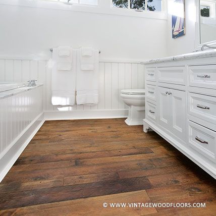 Reclaimed wood gives this classic bathroom a contrast of warmth. #bathroomdesign #flooring | vintagewoodfloors.com Wooden Floors In Bathroom, Wood Floor Tiles Bathroom, Wood Floors In Bathroom, Wood Floor In Bathroom, Wood Flooring Bathroom, French Provincial Bathroom, Hardwood Floors In Bathroom, Farmhouse Basement, Farm Bathroom