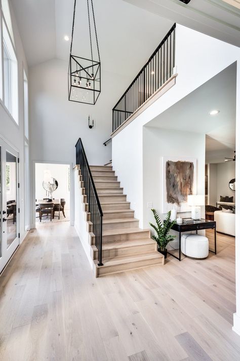 Gorgeous entryway for a transitional modern home Modern Transitional Flooring, Modern Entryway With Stairs, Modern Transitional Staircase, Modern New Construction Home, Modern House Entrance Interior Entryway, Traditional Modern Staircase, Spanish Modern Staircase, Transitional Home Interior Design, Transitional Home Inspiration