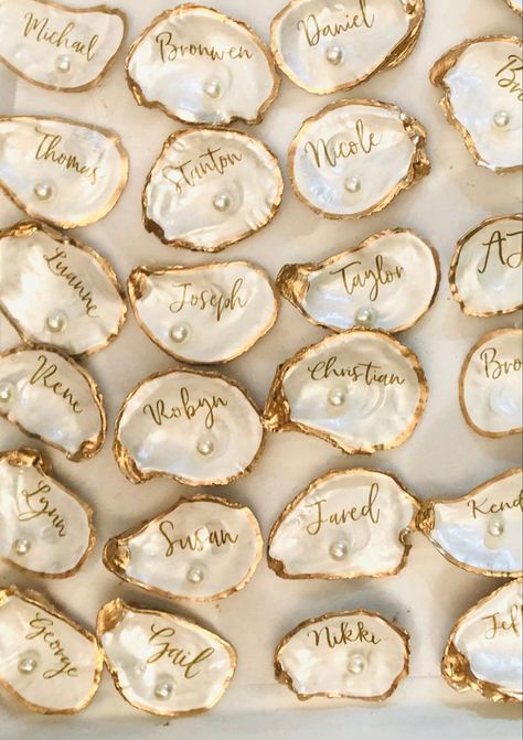 Oyster Decorations Wedding, Beach Wedding Set Up Wedding Table Decor, Seashell Place Cards Wedding, Wedding Place Settings Name Cards, Oyster Shell Wedding Place Cards, Vintage Place Cards Wedding, Oyster Shell Place Cards Diy, Oyster Shell Place Setting, Oyster Place Cards