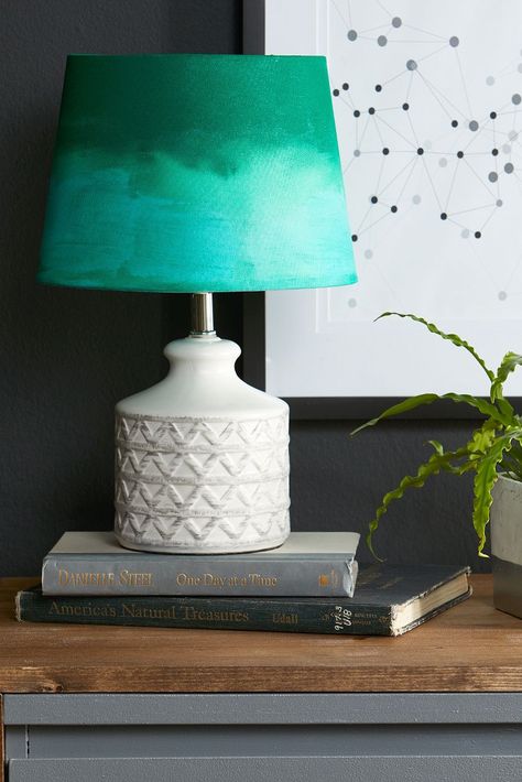 Give ordinary lampshades a lift with easy add-ons that take less than an hour. Our roundup of DIY lampshade ideas has something for every style. #diylampshade #diyideasforyourhome #diyproject #homedecor #bhg Diy Coastal Lamp, Black Fabric Paint, Cover Lampshade, Coastal Crafts, Lampshade Makeover, Painting Lamp Shades, Diy Ombre, Deco Luminaire, Painting Lamps