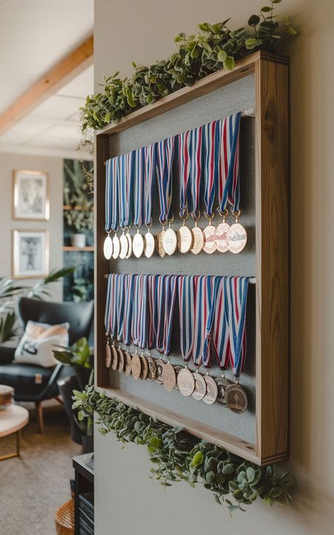 A stylish medal rack displaying a collection of race medals in a neat and organized fashion. Medals Display Ideas, Medal Display Ideas, Race Medal Displays, Sports Medal Display, Medals Display, Running Medal Display, Surf Room Decor, Race Medals, Medal Rack