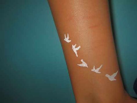 White ink tattoo on brown skin Jewerly Tattoo, Brown Tattoo Ink, White Bird Tattoos, Black People Tattoos, Dark Skin Tattoo, Tattoo Bird, Saved Tattoo, White Ink Tattoo, Bird Tattoo