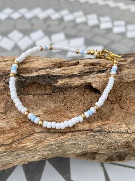 White, Gold and Baby Blue Beaded Bracelet Festival Jewellery, Small Bead Bracelet, White Beads Bracelet, Beaded Braclets, Cute Friendship Bracelets, Blue Beaded Bracelets, Seed Bead Bracelet, Beads Bracelet Design, Gold Bead Bracelets