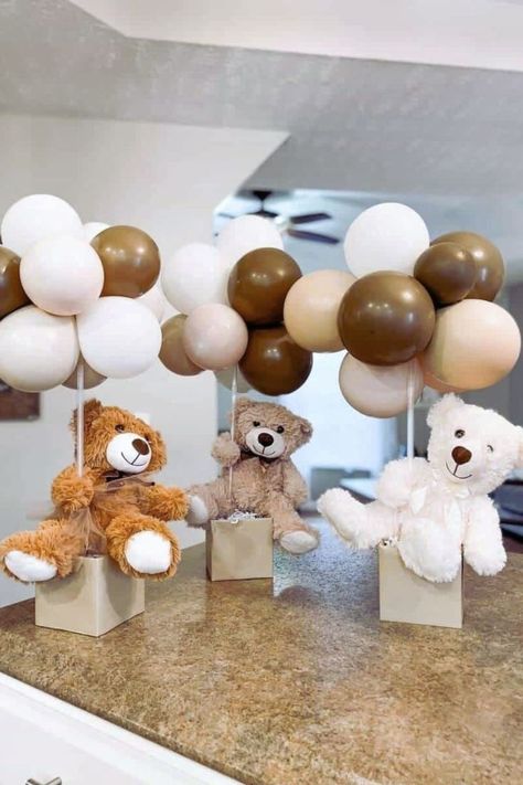 Discover charming teddy bear centerpiece ideas for your next baby shower or child's first birthday. Learn how to craft floating teddy bears with balloons, create adorable hot air balloon settings, and incorporate flowers for a soft, whimsical touch. These DIY decorations are easy to assemble with supplies from your local Dollar Tree, making them affordable yet unforgettable. Teddy Bear Wrapping Ideas, Bear Centerpiece Ideas Diy, Balloon Hot Air Balloon Diy, Floating Teddy Bear Balloon, Bear Centerpiece Ideas, Bear Centerpieces, Bear Centerpiece, Teddy Bear Centerpieces