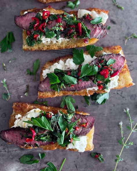 Steak + Burrata Bruschetta - The Virtual Caterer Steak And Burrata, Steak Burrata, Pan Background, Burrata Bruschetta, Bruschetta Recipes, Oregano Flowers, Steak Peppers, Toasted Crostini, New Years Appetizers