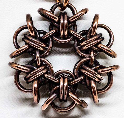 Pixie Link Snowflake  This is a snowflake made with six pixie links woven onto a larger ring then connected on the sides. Copper has been treated with LoS.    There is an inner 14 swg 1/2" ID ring, most of the units are made with 18 swg 1/4" ID with the "wings" being 16 swg 7/32" ID. They are then connected by 18 swg 7/32". Snowflake Tutorial, Chainmaille Jewelry Patterns, Jump Ring Jewelry, Chainmaille Jewelry, Chainmail Jewelry, Rings Ideas, Woven Ring, Chainmaille Bracelet, Chain Maille Jewelry