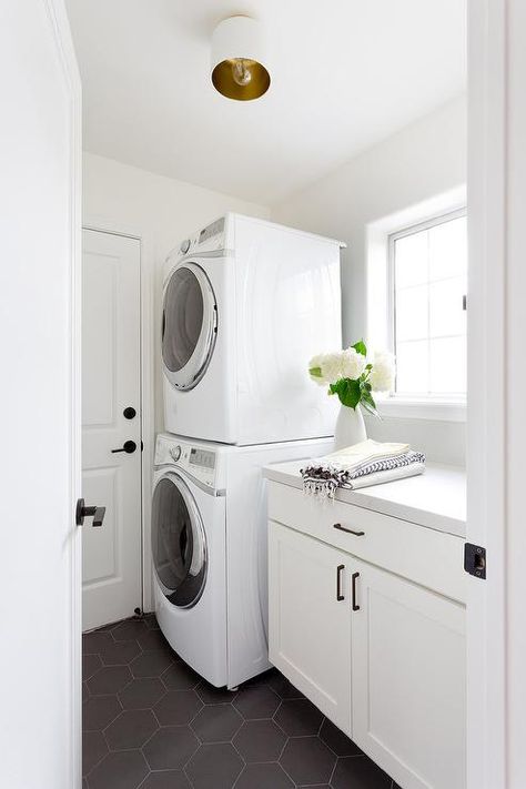 Stacked Washer and Dryer with Large Black Hex Tiles Countertops With White Cabinets Quartz, Kitchen Countertops With White Cabinets, Stacked Washer And Dryer, Laundry Room Stackable, Bright Laundry Room, Laundry Reno, Hex Tiles, Transitional Laundry Room, Stacked Laundry Room