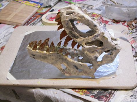 Dinosaur skull paper mache Steampunk Classroom, Paper Mache Dinosaur, Dinosaur Christmas Tree, Rex Costume, Paper Dinosaur, Dinosaur Birthday Theme, T Rex Costume, Dinosaur Head, Cardboard Sculpture