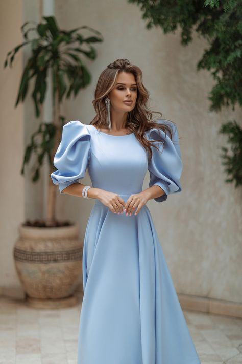 Embrace the magic of sky-blue with our Sky-Blue Backless Puff-Sleeve Midi Dress. The mesmerizing color evokes a sense of tranquility and beauty, while the backless design adds a daring and sultry touch. #mididress #skybluedress #bluedress #dress #dresses #womenwear #stylish #chic #backless #elegant #dressup #dresslover #weddingdress #eveningdress Modest Blue Dresses, Puff Sleeve Dress Formal, Elegant Modest Dresses, Blue Classy Dress, Sky Blue Dresses, Blue Dress Aesthetic, Dress Simple Elegant, Sky Blue Outfit, Elegant Silk Dresses