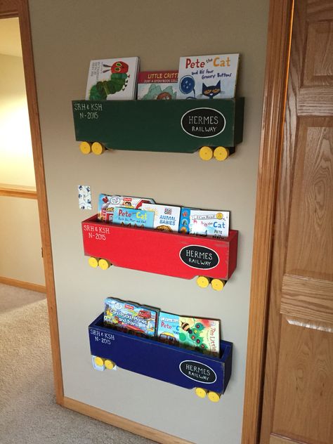 Train box car book shelves. I followed the instructions from the link below. I did use a different paint. I also customized the letters for our family name and the date since my little guy was born in Nov of 2015.   https://www.pinterest.com/pin/447052700489929870/ Train Shelf, Train Box Car, Car Book, Name Decor, Train Room, Pete The Cat, Book Shelves, Boy Bedroom