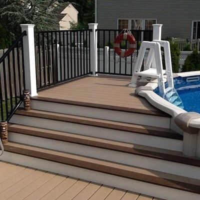 Wolf decking Deckorators CXT railing with black aluminum  deckorators balusters with faux stone skirting Above Ground Pool Deck, Pool Decking, Pool Deck Plans, Swimming Pool Decks, Deck Pictures, Above Ground Pool Landscaping, Above Ground Pool Decks, Backyard Pool Landscaping, Above Ground Swimming Pools