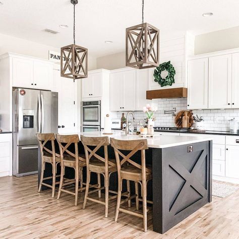 The traditional cross beam island, wooden accent bar stools, and rustic hanging light fixtures contribute to the traditional country feel of this kitchen. Image via FarmhouseHub on Pinterest. Kitchen Island Remodel Ideas, Rustic Farmhouse Kitchen Island, Kitchen Island Lighting Ideas, Farmhouse Kitchen Island Lighting, Island Lighting Ideas, Pendant Designs, Farmhouse Kitchen Island, Rustic Farmhouse Kitchen, Farmhouse Kitchen Design