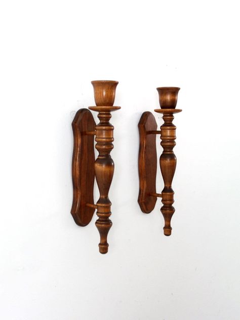 This is a pair of vintage turned wood candle holder sconces. Bring the warmth and charm of classic craftsmanship into your home with these beautifully carved wood candle holders. They'll add a touch of elegance and nostalgia to any room, creating a cozy atmosphere perfect for relaxing or entertaining. CONDITION In good condition with wear consistent with age and use.  MEASUREMENTS Height:  15.75"  ..  40 cm Width:  3"  ..  7.6 cm Depth:  4.5" ..  11.4 cm 42417 Wooden Candle Sconces, Wood Turned Candle Holders, Wood Sconces, Sconces Vintage, Wood Candle Holder, Wood Candle, Wooden Candle, Candle Sticks, Wood Candle Holders