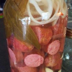 Reduced water to 2c, added 1Tbsp crushed red pepper, 1tsp cayenne, 4 garlic cloves, 2 bay leaves, 1 sliced onion, and 2Tbsp hot sauce. Pickled Bologna, Pickled Meat, Pickled Sausage, Pickled Things, Pickled Eggs Recipe, Little Smokies, Smoked Sausage Recipes, Canning Recipe, Polish Sausage