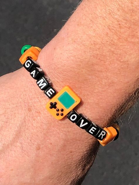 GAME OVER Kandi Beaded Bracelet - Etsy Kandi Bracelets Aesthetic, Kandi Gameboy, Character Inspired Kandi, Kandi Gameboy Pattern, Trans Kandi Bracelet, Rave Kandi Ideas, Pony Bead Jewelry, Epic Kandi Cuff, Halloween Beads