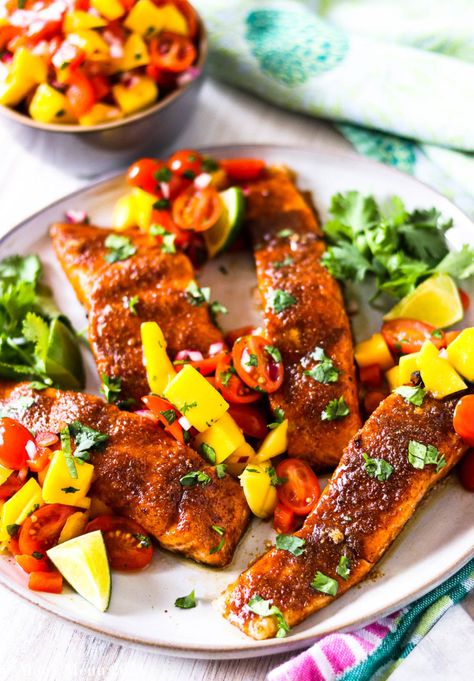 Looking for hot summer dinner recipe ideas? Look no ofruther than this spicy salmon with mango salsa! With quick prep, fresh ingredients, and only 12 minutes of cooking time, you can get on with your fun summer evenings. Add this to your list of summer time dinner ideas today! #summerdinnerideaseasy #salmon #dinnerideas #summertimedinnerideas Summer Time Dinner Ideas, Salmon With Mango Salsa, Dinner Party Entrees, Salmon With Mango, Brown Sugar Salmon, Party Entrees, Mango Salsa Salmon, Baked Salmon Recipe, Mango Salsa Recipes