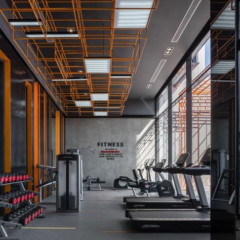 The LINE Sukhumvit 101 (I) Interior | Wison Tungthunya & W Workspace Industrial Gym Design, Fitness Interior Design, Gym Interior Design Ideas, Fitness Interior, Orange Gym, Fitness Flooring, Fitness Center Design, Gym Design Interior, Small Home Gym