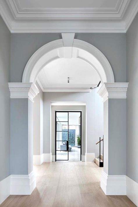 In the entryway, the architect seamlessly combined the existing heritage features with an expansive new extension. For example, the hallway, features a Victorian arch leading toward a glass steel door that opens onto the home's new addition | Photography: Jack Lovel Victorian Arch, Modern Victorian Homes, Victorian House Interiors, Victorian Interior Design, Victorian Hallway, Victorian Home Interior, Victorian Style Homes, Victorian Interior, Victorian Interiors