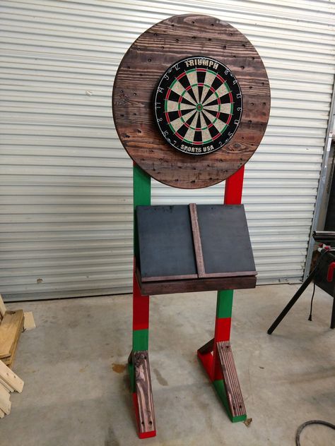 Custom dart board stand with chalkboard and storage Portable Dart Board Stand Diy, Outside Dart Board Ideas, Outdoor Dart Board Ideas, Dart Board Stand, Diy Dart Board, Dart Board Ideas, Dartboard Stand Diy, Outdoor Darts, Dartboard Ideas