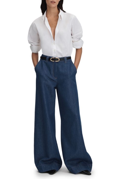 A high waist and dramatic wide-leg silhouette make these on-trend jeans crafted from stretch denim the essence of elegant comfort. 31" inseam; 26" leg opening; 12 3/4" front rise; 16" back rise (size 29) Zip fly with button closure Front slant pockets; back patch pockets 63% cotton, 37% lyocell Dry clean or machine wash, dry flat Made in Turkey Wide Dark Blue Jeans Outfit, Dark Denim Wide Leg Jeans, Wide High Waist Jeans Outfit, Dark Blue Wide Leg Jeans Outfit, Dark Blue Trousers Outfit, Wide Jeans Outfit High Waist, Wide Leg Pants Outfit Fall, Dark Denim Outfit, Outfits With Wide Leg Jeans