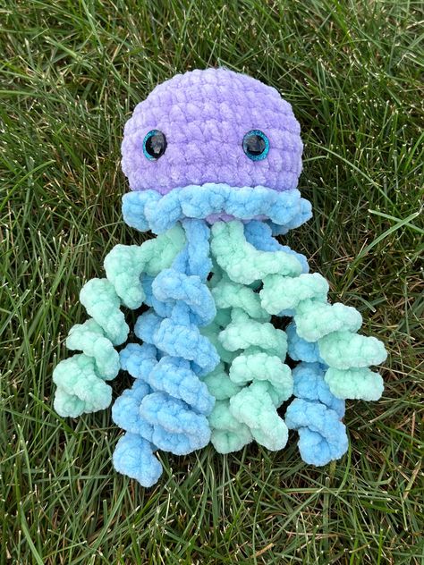 Adorable handmade crochet jellyfish plushie! Don't miss out on this unique one of a kind creation. The plushie in the photos is the exact plushie you will receive. Perfect gift for any occasion! Made with soft chenille yarn and plastic safety eyes. The eyes are a choking hazard. This is a decorative item not intended for small children or animals. Jellyfish pattern by @ Plushie Amigurumi Free Pattern, Chenille Yarn Projects, Chenille Yarn Crochet Patterns, Crochet Stuffys, Crocheted Plushies, Jellyfish Crochet Pattern, Crochet Jellyfish, Pokemon Crochet Pattern, Crocheted Things