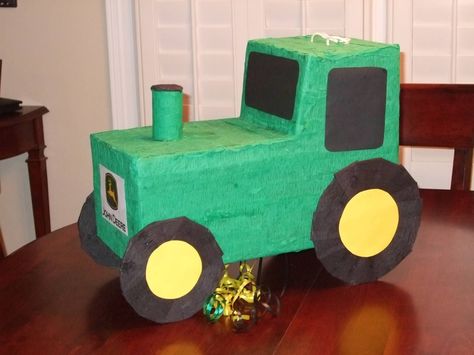 John Deere tractor pinata.  I cut it out from a diaper box and used green crepe paper to cover it.  Added on the wheels, smoke stack etc.  Crepe paper to cover all green and black surfaces with extra tag/poster paper for the windows and wheel centers.  Pulled JD logo off of Web and printed out.  Made a cutout in the bottom with a trap pull-string door if needed. Tractor Pinata, John Deere Birthday Party, John Deere Party, John Deere Birthday, Kids Valentine Boxes, Tractor Birthday Party, Tractor Party, Farm Theme Birthday, Farm Themed Birthday Party