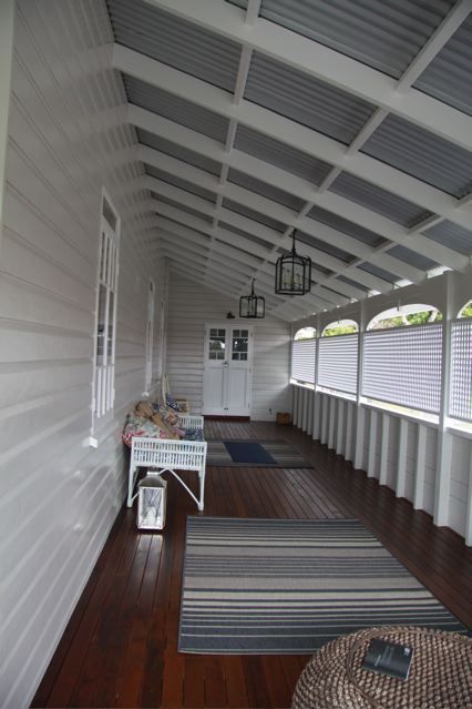 Queenslander home enclosed verandah Beautiful dark timber decking  and white colours on the weatherboard of the home along with the white lattice screening the verandah.  All complimented with grey colorbond roof. Just perfect for Australian conditions. #deck #patios #verandah #roofing Workers Cottage, Queenslander Renovation, Queenslander House, Front Verandah, Roof Architecture, Patio Roof, Pergola Plans, Style Tile, Exterior House Colors