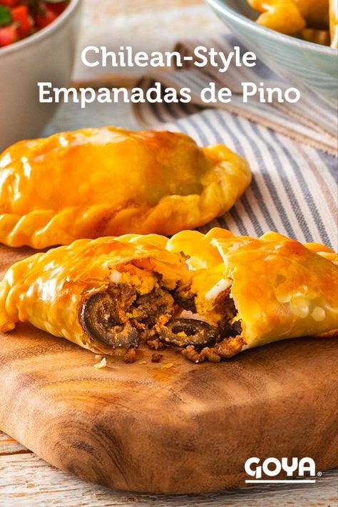 Prepare these delicious and flaky Chilean-Style Empanadas de Pino, a staple of Chilean cuisine, at home. This recipe is made with the convenient and practical GOYA® Empanada Dough-Criollas for Baking and Frying, and filled with a savory combination of ground beef, black olives, raisins and sliced hard-boiled eggs. Serve with pebre, the traditional sauce that enhances their incredible flavor. Empanadas Argentinas Recipe, Pumpkin Empanadas, Baked Empanadas, Pasties Recipes, Raisin Recipes, Empanadas Dough, Venezuelan Food, Chilean Recipes, Beef Empanadas