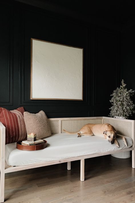 A moody office painted Greenblack by Sherwin Williams. DIY plaster canvas art, fluted side table, modern wall molding and cane daybed. Cane Daybed, Fluted Table, Moody Office, Diy Daybed, Christmas Miracle, Day Bed, Plaster Art, Wall Molding, Diy Furniture Couch