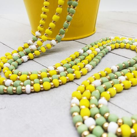 This waist beads two-strand set is created with matte yellow and green beads. One strand is heavy with lemon yellow, the other is heavy with lime green. A fun duo that can be worn side-by-side or layered high-and-low... •Yellow: Joy and optimism... •Green: adaptability, fruitfulness, self-love... •White: peace, humility, purity, healing... •Gold: wisdom, wealth, manifestation... Yellow Waist Beads, Waist Beads African, Wealth Manifestation, Beaded Earrings Diy, Ties That Bind, Waist Beads, Earrings Diy, Green A, Green Beads