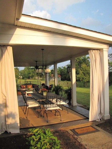 patio makeover: stained concrete slab with diamond tile pattern, lanterns hanging on posts, curtains Concrete Patios, Patio Privacy, Patio Curtains, Backyard Porch, Patio Diy, Patio Roof, Patio Makeover, Pergola Patio, Patio Lighting