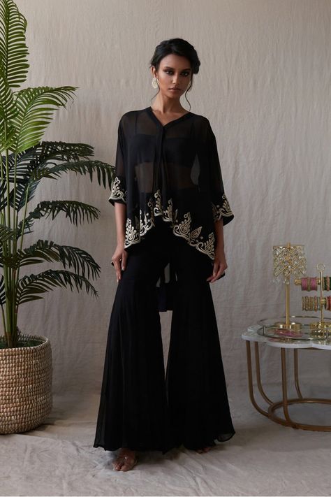 Black sharara set with a high low top with a thread embroidered hem and pants, in georgette. Lycra inner included Pakistani Straight Suits, Black Sharara Designs, Black Sharara Suit Party Wear, High Low Dress Indian, Black Cocktail Outfit, Black Sharara Suit, Straight Kurti Designs, Black Sharara, Desi Fusion