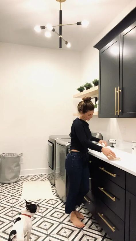 Laundry Room Next To Garage Door, Lvp Laundry Room, Black White And Gold Laundry Room, Laundry Room Ideas Black Cabinets, Laundry Room Black Tile Floor, Black Laundry Cabinets, Laundry Room With Black And White Tile, Black Cabinet Laundry Room Ideas, Iron Ore Laundry Room Cabinets