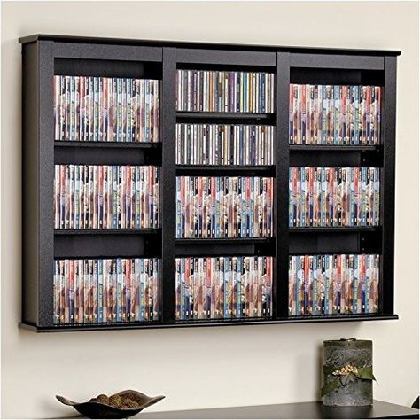 PRICES MAY VARY. Cherry Black laminate finish Holds 523 CDs, 213 DVDs, 124 VHS or 108 " Disney" videos Or any combination of the above Easy to mount system Ready to assemble. A beautiful mix of practical storage and modern home decor fashion, the Triple Floating Media Wall Storage cabinet is designed to manage a large collection of CDs or DVDs with style. Mount on your wall as a stand-alone multi-media cabinet or use two, one above the other, to create a storage system that allows easy access to Wall Mounted Storage Shelves, Wall Storage Cabinets, Media Storage Cabinet, Media Shelf, Cd Storage, Dvd Storage, Game Storage, Wall Mounted Cabinet, Mounted Shelves