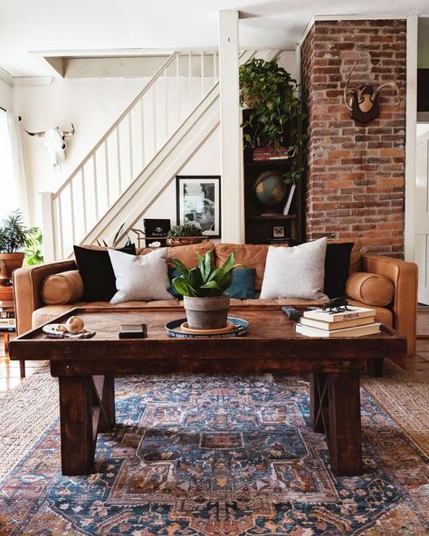 A boho style living room with open brickwork, a patterned rug and chunky wooden furniture. I love the shape and style of the leather rug. Lounge Vibes, Western Massachusetts, Decor Hacks, Bohemian House, Eclectic Living Room, Farmhouse Decor Living Room, Design Del Prodotto, House Projects, Winter Trends