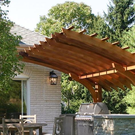 Trellis Structures on Instagram: "The design of this backyard in New Jersey was a catalyst to create a very dynamic outdoor kitchen pergola. This contemporary home featured several very prominent arched windows. Working with these architectural details, the homeowner's landscape designer created a circular patio to encompass a new outdoor dining and kitchen area. We continued that theme designing a cantilevered structure that provided a visual framing device accenting the existing style of the surroundings. The cantilevered pergola, while maintaining an open feeling, provides a sense of intimacy and privacy where it was needed. Several unique engineering solutions were incorporated to facilitate the cantilever, thereby keeping the patio free from vertical support posts, per the request of Cantilevered Pergola, Outdoor Kitchen Pergola, Cantilever Pergola, Kitchen Pergola, Circular Patio, Landscape Designer, Trellis Design, Patio Designs, Rooftop Garden