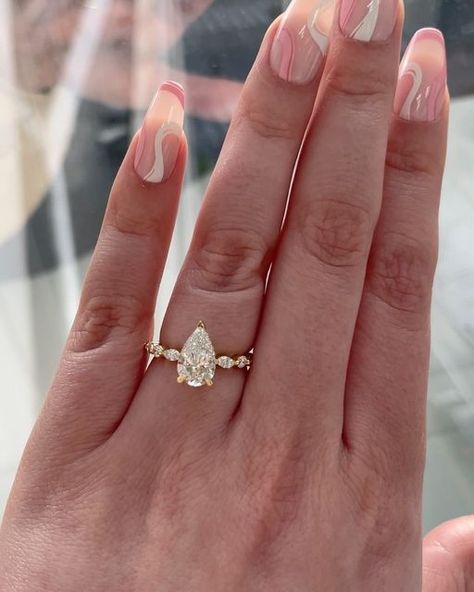 Wundercut on Instagram: "Side Stone Rings💍 Side stone engagement rings feature complementing diamonds or gemstones, which bring out the brilliance of the center stone. Side stones can be any cut, either matching or contrasting with the main stone of the engagement ring✨ Save for inspo!💍 . . wedding rings, pear shape diamond, custom jewelry, hidden halo, yellow gold, bride to be, bridal inspo #weddingrings #pearshapediamond #shesaidyes #customjewelry #yellowgold #yellowgoldring #peardiamond #e Wedding Rings Pear Shape, Wedding Rings Pear, Pear Engagement Ring Halo, Side Stone Engagement Ring, Pear Engagement Ring, Bridal Inspo, Ring Ideas, Hidden Halo, Stone Engagement Rings