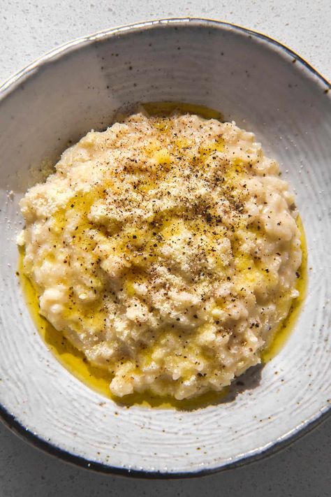 A brightly lit image of a white speckled ceramic bowl filled with cacio e pepe risotto topped with garlic infused ghee. The bowl sits on a white stone bench top. Winter Gluten Free Recipes, Low Fodmap Risotto, Oat Risotto, Picnic Meals, Cauliflower Rice Risotto, Vegetarian Risotto, Yummy Pasta, Winter Dishes, Risotto Recipes